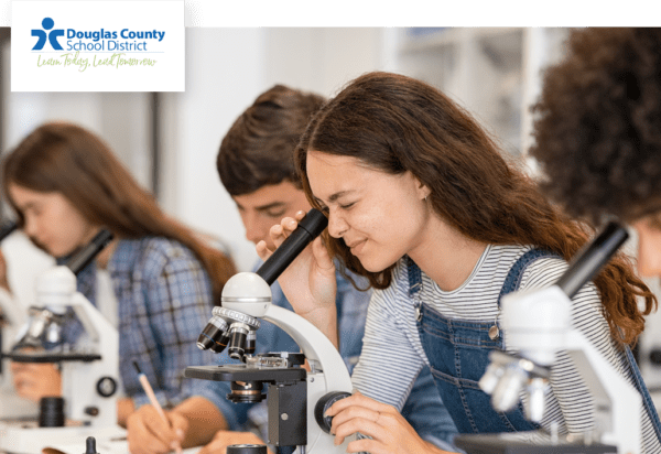 DCSD student looking through microscope