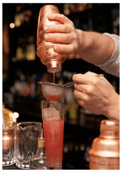 Bartender pouring mixed drink